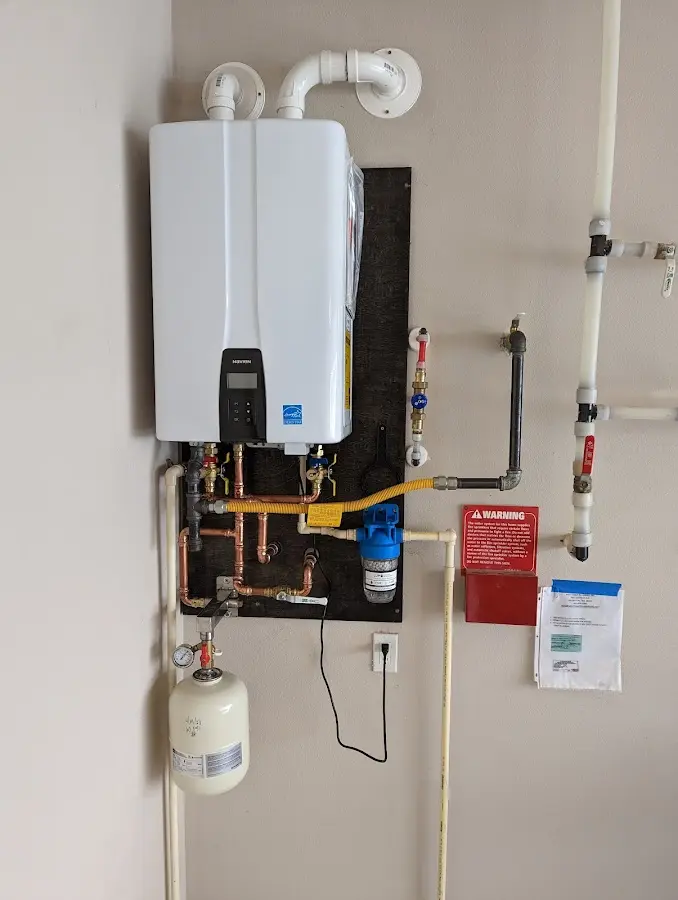 Professional plumber installing copper piping in a Ogden home